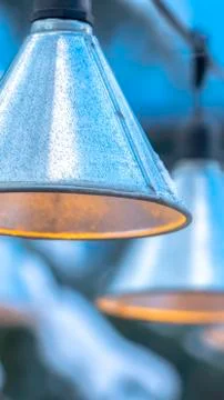 Vertical frame Decorative cone shaped lamps hanging on black strings outside Foto stock