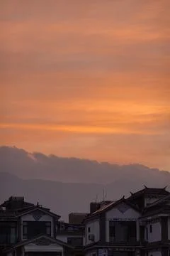 Vertical Frame of Ember Sky and Village Eaves Stock Photos