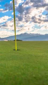 Vertical frame Flagstick or pin and hole or cup in the middle of putting green Stock Photos