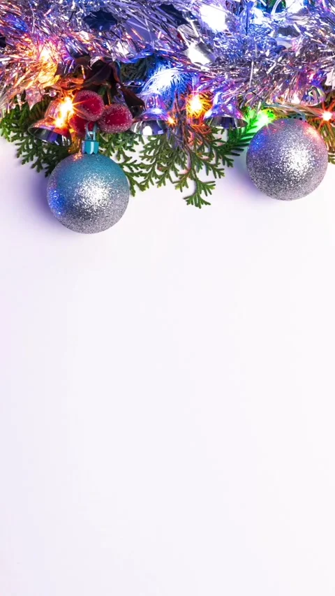 Vertical Frame green pine branch with Christmas balls, shiny tinsel and light Stock Footage 313075640