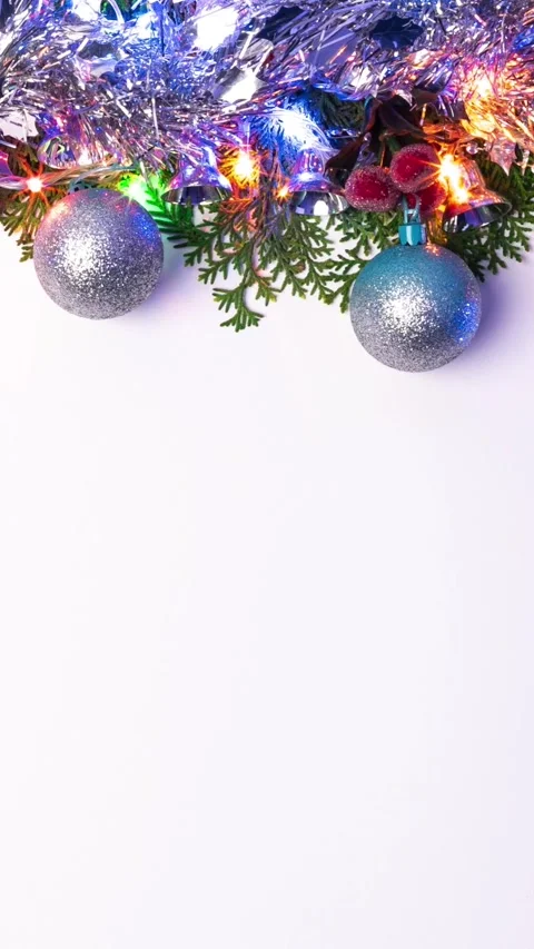 Vertical Frame green pine branch with Christmas balls, light and serpentine Stock Footage 317110522
