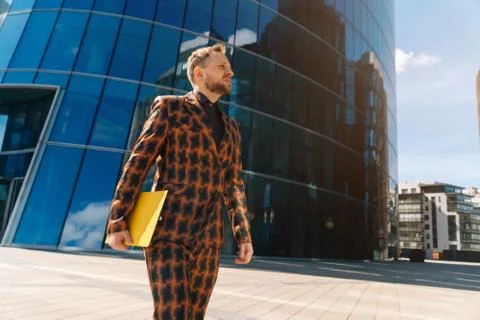 Vertical frame of a handsome young man in an official orange suit with a yell Stock Photos