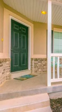 Vertical frame Home facade with yard and stairs in front of the small porch with Stock Photos