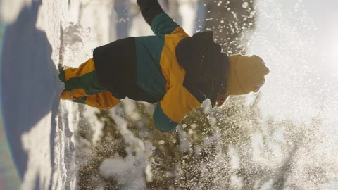 Vertical frame The joy of a smiling child dancing in fresh snow showcases the Stock Footage 293757258