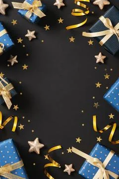 Vertical frame made from gift wrapping supplies. Blue wrapping paper, gold ri Stock Photos