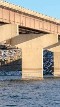 Vertical frame Massive abutments supporting the span of a beam bridge over blue Stock Photos