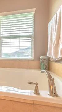 Vertical frame Modern spa bath with warm window lighting Stock Photos