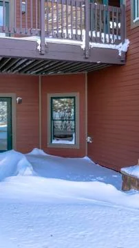 Vertical frame Mountain home facade with balcony over double glass doors and Stock Photos