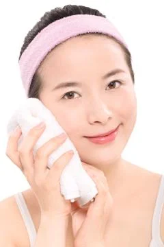 Vertical frame Oriental figures Just one woman. Wash your face. Cleaning Luxx Stock Photos