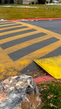 Vertical frame Paved road painted with yellow diagonal stripes between parallel 库存照片