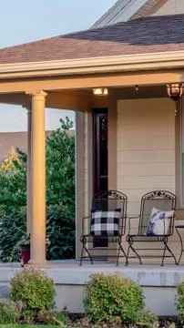 Vertical frame Rustic chairs with cushions on a veranda Stock Photos