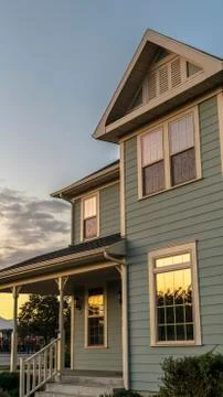 Vertical frame Sunset reflected in the windows of a timber house Stock Photos