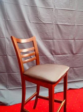 Vertical frame tall bar stool in the studio interior Sublime wooden chair Stock Photos