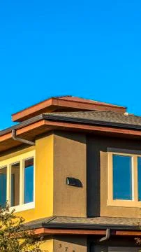 Vertical frame Upper storey of a house lined with rectangular windows against Stock Photos