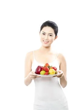 Vertical frame Vitamins Look at the camera. Fruit Adult Portrait Young woman Stock Photos