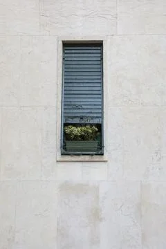 Vertical frame of a wall with an old narrow window Foto stock