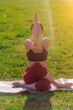 Vertical frame of a young athletic attractive woman practicing yoga, performi Stock Photos