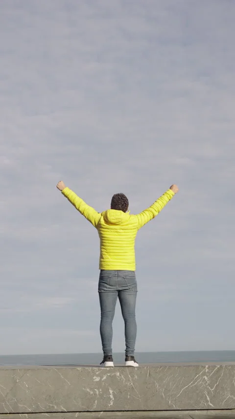 Vertical frame of young man raising hands to sky. Stock Footage 222565767