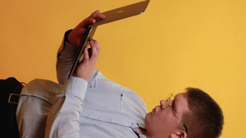 Vertical freelance work overweight man laptop Stock Footage 282667742