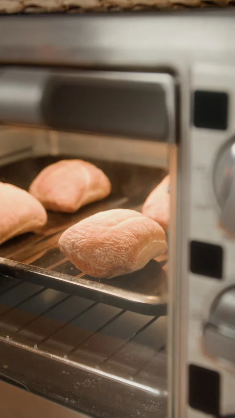 Vertical of Fresh Ciabatta Bread Rolls Baking in Countertop Toaster Oven Stock Footage 340343086