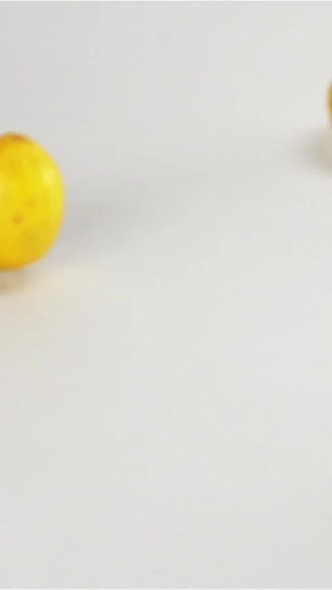 Vertical of Fresh yellow lemons falling down on white surface Stock Footage 305516382