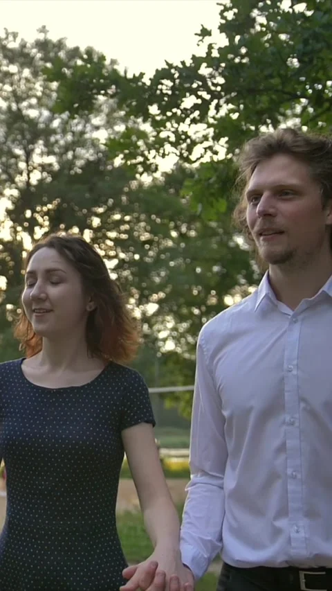 Vertical of Front portrait view of young couple, man and woman, holding hands Stock Footage 278481578