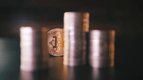 Vertical front view closeup of golden bitcoin on pile of metallic coins on dark Stock Footage 87280204