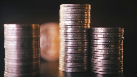 Vertical front view closeup of golden bitcoin on pile of metallic coins on dark Stock Footage 87280485