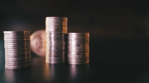 Vertical front view closeup of golden bitcoin on pile of metallic coins on dark Video stock 87281740