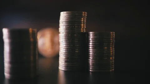 Vertical front view closeup of golden bitcoin on pile of metallic coins on dark Stock Footage 87304404