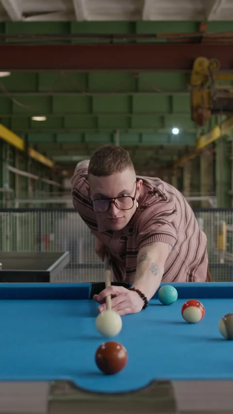 Vertical Front View of Man Aiming Cue Ball on Pool Table Stock Footage 332764375