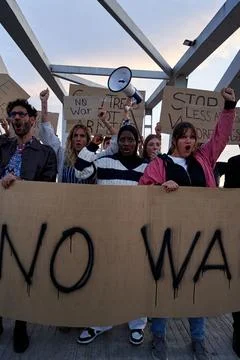 Vertical front view of multiracial group of people manifesting together against Stock Photos