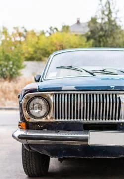 Vertical front view of old dark blue rusty car vehicles with headlight Stock Photos