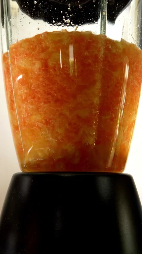 Vertical - Fruit being mixed in an electric blender to create a thick drink. Video stock 280112466
