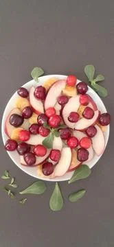 Vertical fruit plate on black background Stock Photos