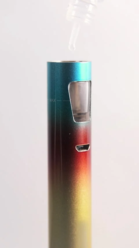 Vertical full HD macro footage of filling an electric cigarette with eliquid Stock Footage 310196309