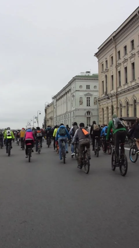 Vertical Full HD video. Back view. Group of cyclists riding down street road Stock Footage 278118761