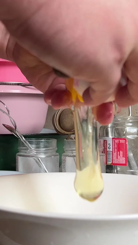 Vertical Full HD video. Man with knife breaks chicken egg at kitchen Video stock 277236470