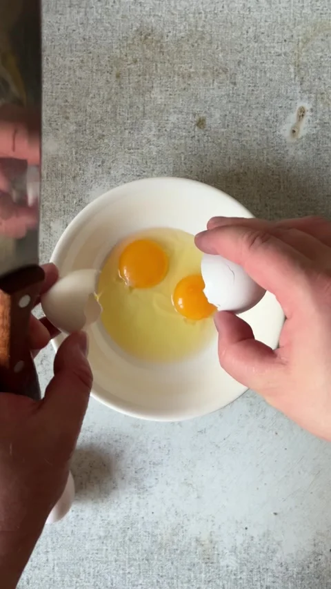 Vertical Full HD video. Man with knife breaks chicken egg at kitchen Stock Footage 278119135