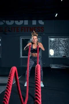 Vertical full length shot of an athletic fitness woman doing functional training Stock Photos