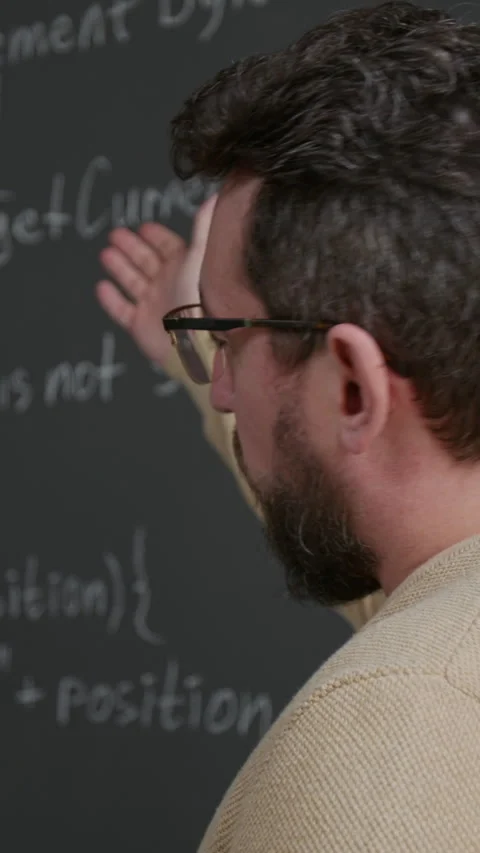 Vertical of Geeky Young Male Coding Teacher Explaining Script at Lesson Stock Footage 318727513