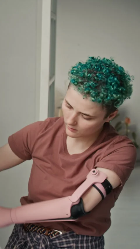 Vertical of Gen Z Girl with Bionic Arm Covering Furniture with Plastic Film 스톡 동영상 323296333