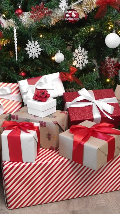 Vertical Gift boxes under a contemporary Christmas tree in a home. Happy Xmas Stock Footage 313075774
