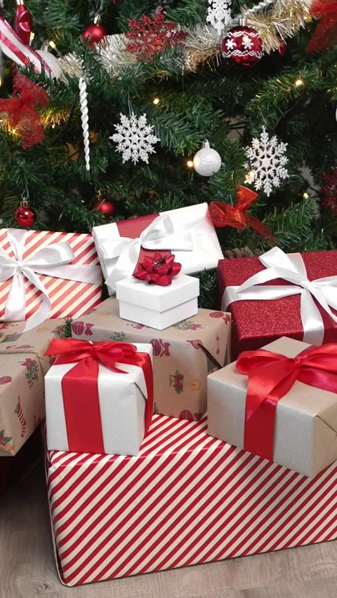 Vertical Gift boxes under a contemporary Christmas tree in a home. Happy Xmas Stock Footage 315237302