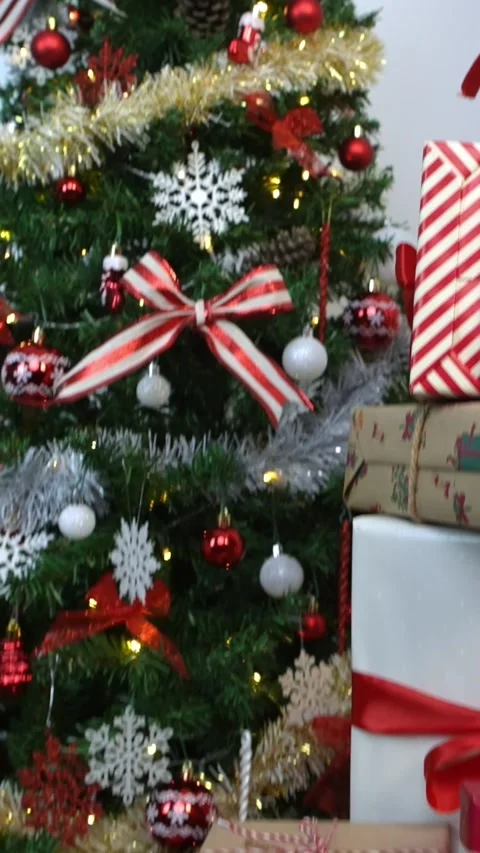 Vertical Gift boxes under a contemporary Christmas tree in a home. Happy Xmas Stock Footage 315237332
