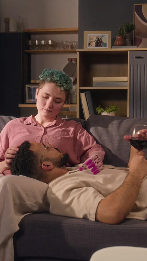 Vertical of Girl with Bionic Arm Stroking Hair of Boyfriend Lying on Her Lap 스톡 동영상 327794205