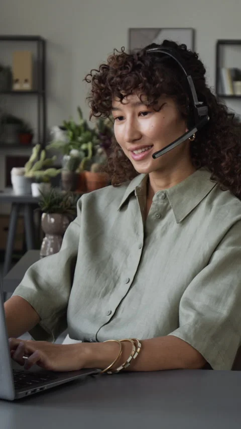 Vertical of Girl with Headset Providing Customer Support on Laptop Stock Footage 343616266