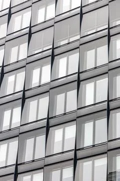 Vertical glass facade with repeated windows. Modern architecture pattern. Stock Photos