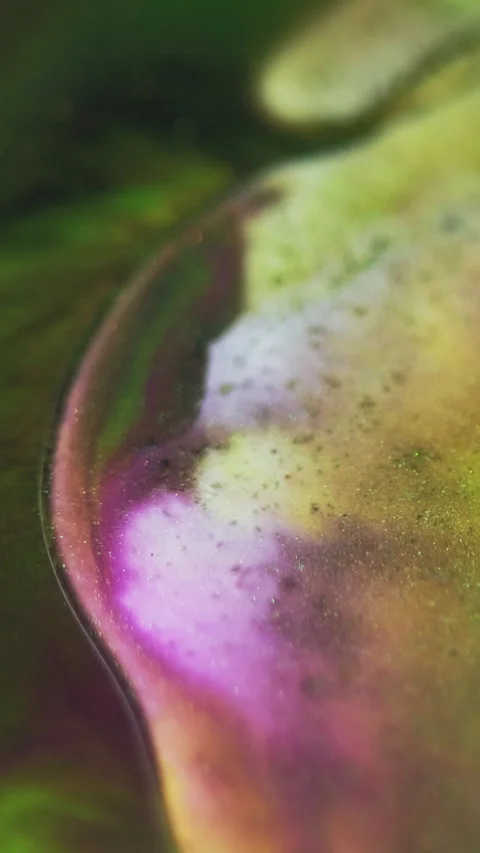 Vertical Glitter fluid oil bubble paint mix purple green Stock Footage 278170724