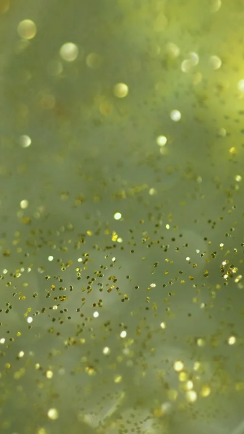 Vertical Glitter gel flow sparkling fluid golden green wave Stock Footage 284789434